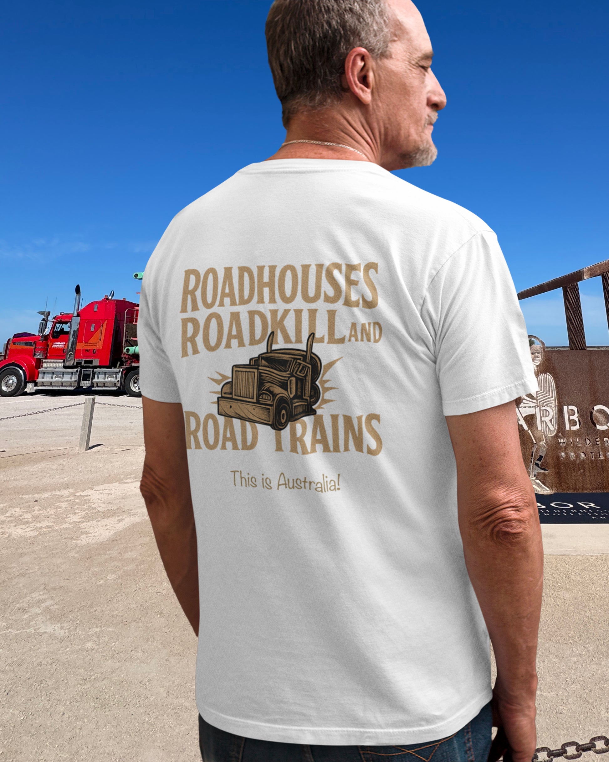 Man wearing a t-shirt with a truck graphic and text, roadhouses, roadtrains and roadkill. Australian graphic tee